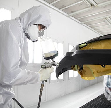 Collision Center Technician Painting a Vehicle | Coughlin Toyota in Heath OH