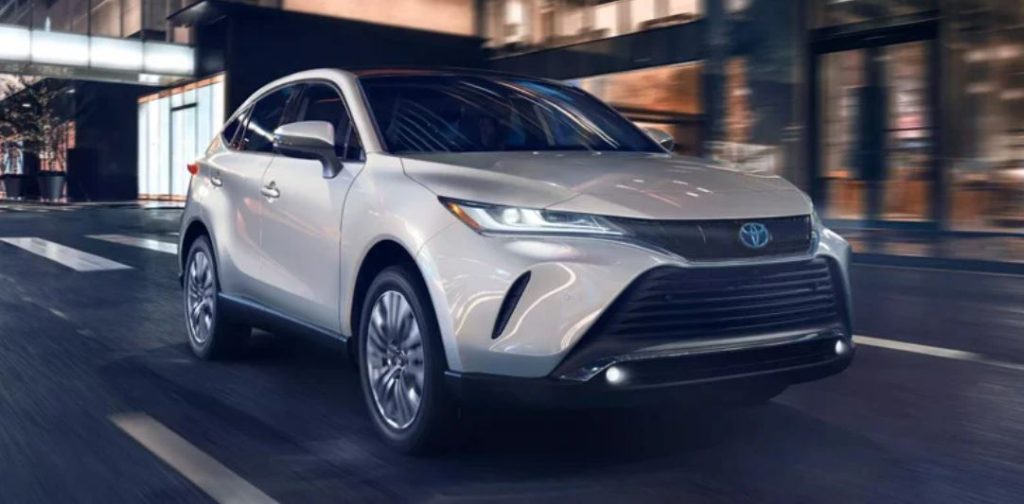 A white 2022 Toyota Venza driving down the road.