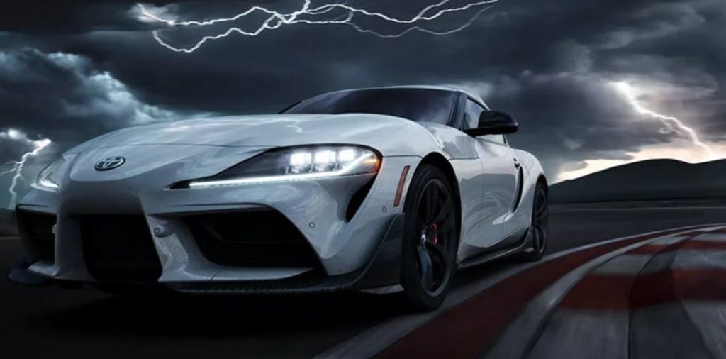 A dramatized and highly edited image of a Toyota Supra driving on a stormy day with lightning in the background.